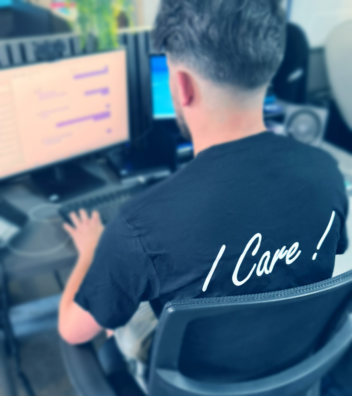 Hughes Team Member talking to client wearing I Care! t-shirt